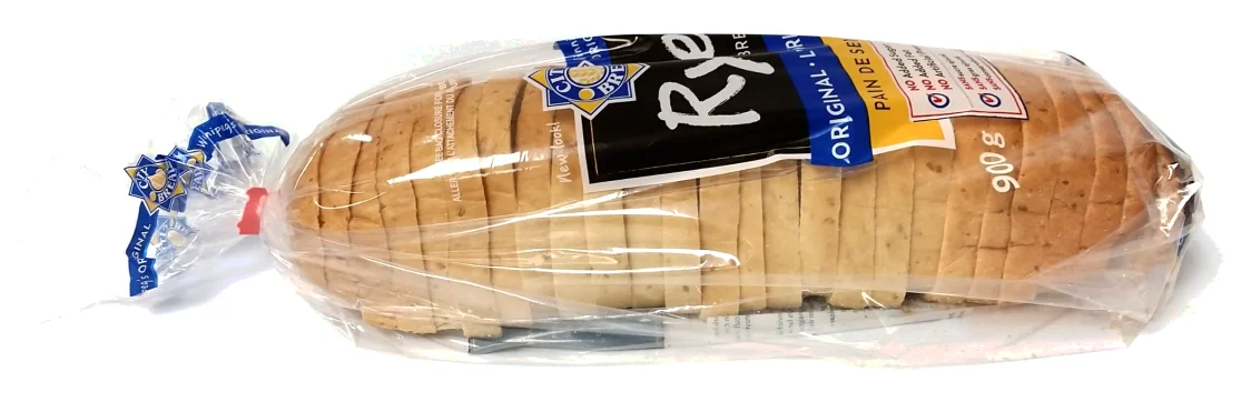 Sliced rye loaf in a clear printed bread bag closed with a twist tie