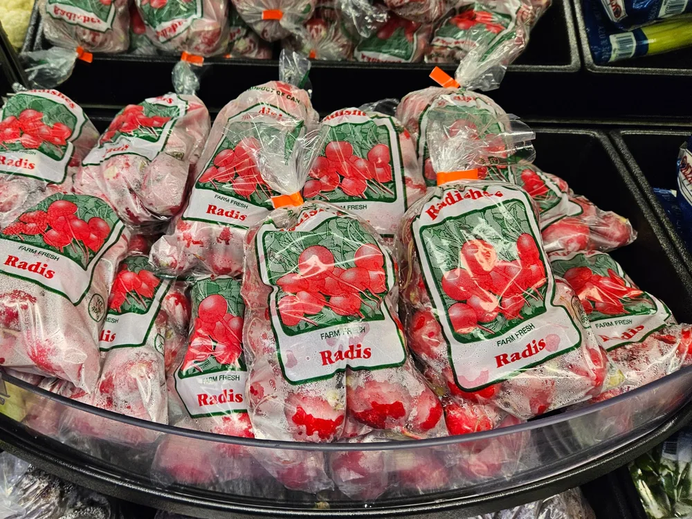 Friesen stock Radishes / Radis 1 lb printed bags in a grocery produce display